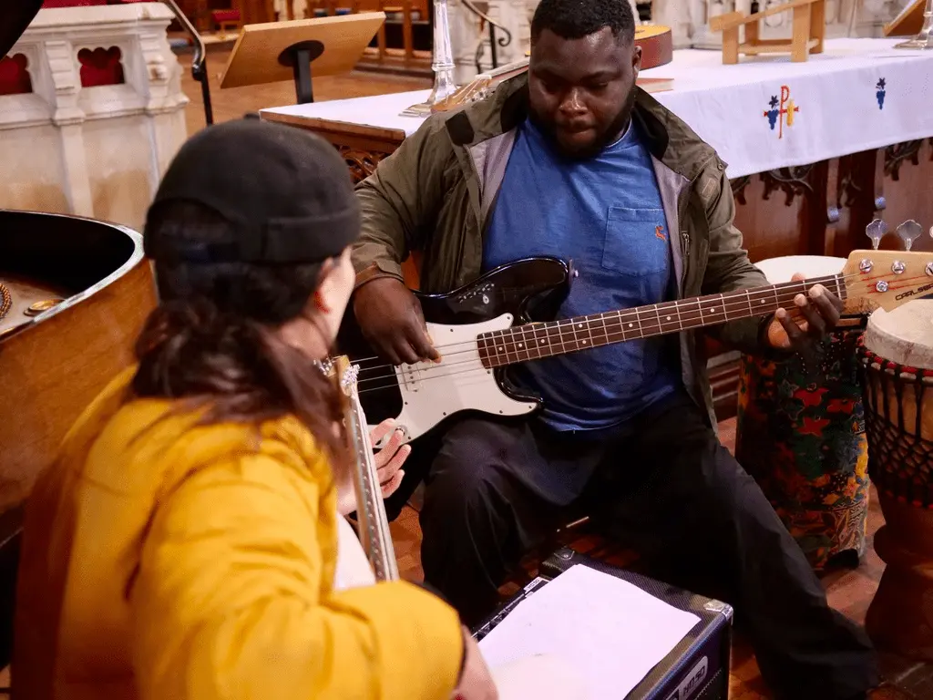Two people playing guitar during a Dovetail Orchestra session